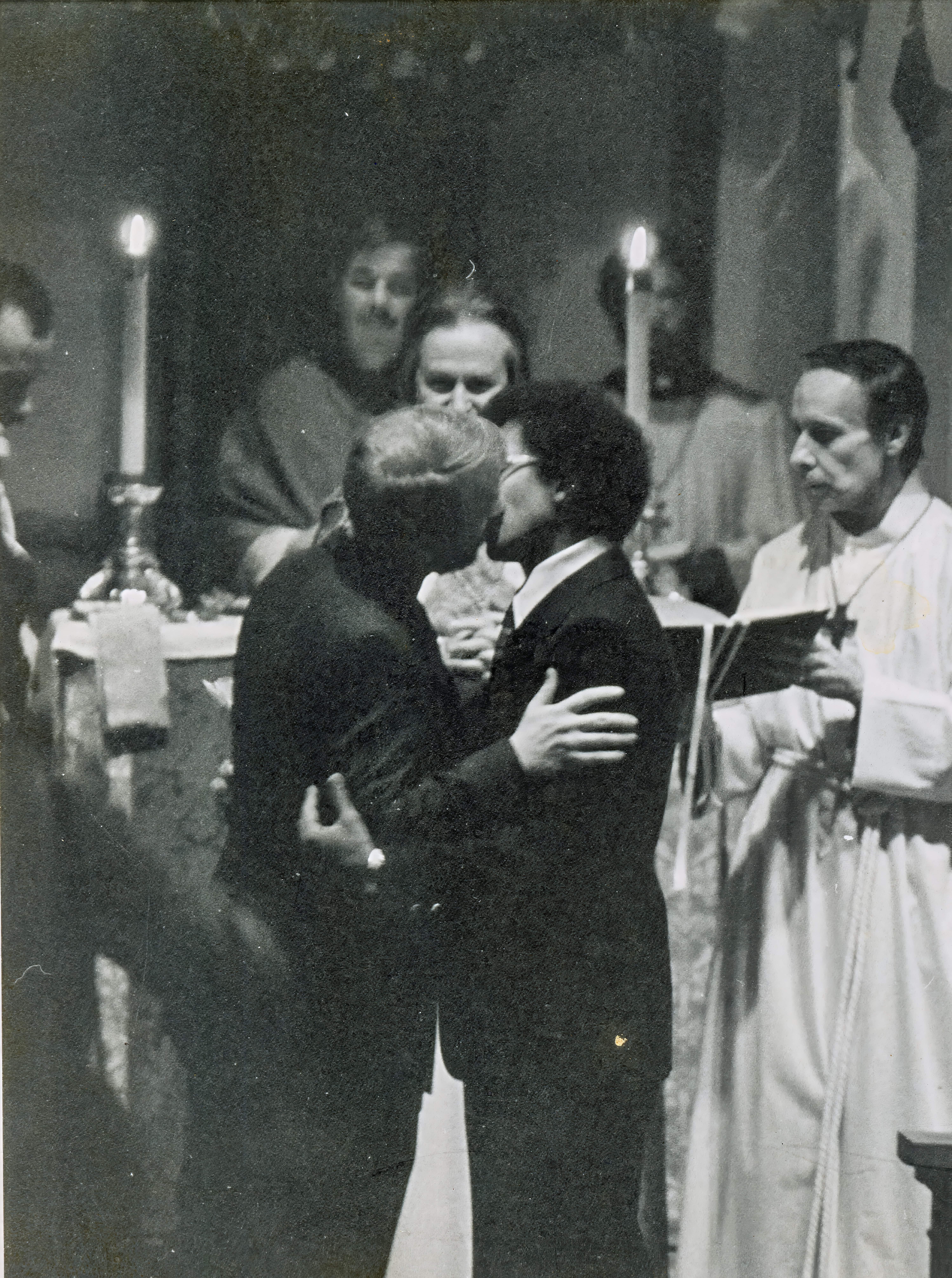 After exchanging vows and rings, John C. Fout and Israel seal their covenant with a kiss as Fr. John Darcy Noble and assisting clergy look on. The public blessing of same-sex couples formed the heart of the Church of the Beloved Disciple's ministry, offering LGBTQ Christians a sacramental affirmation of their relationships nearly four decades before marriage equality became the law of the United States.
