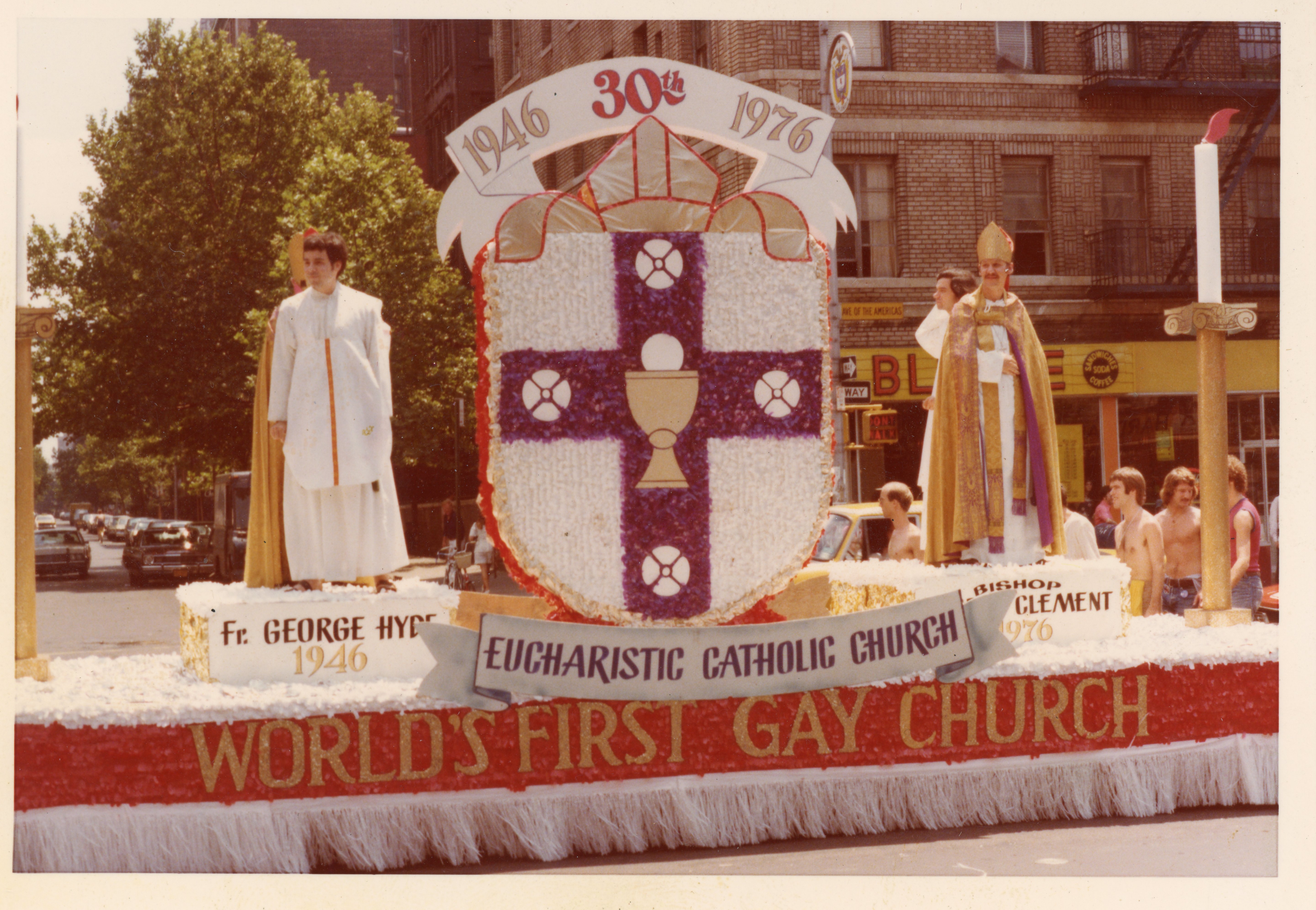 The Church of the Beloved Disciple's float at the Seventh Annual Christopher Street Liberation Day March commemorated the thirtieth anniversary (1946–1976) of Archbishop George Augustine Hyde's Eucharistic Catholic Church. Featuring congregation members portraying Archbishop George Augustine Hyde and Bishop Robert Mary Clement, the float presented the Church of the Beloved Disciple as the spiritual successor to Hyde's pioneering ministry. The central heraldic emblem, created by the Church of the Beloved Disciple to represent the Eucharistic Catholic Church, symbolized that continuity, while the prominent inscription "World's First Gay Church" proclaimed the congregation's understanding that Hyde's church was the earliest sacramental Christian community in the United States established to minister openly to gay men and lesbians. Through this public display, the Church of the Beloved Disciple celebrated and extended that legacy as an LGBTQ-affirming Catholic ministry in New York City.