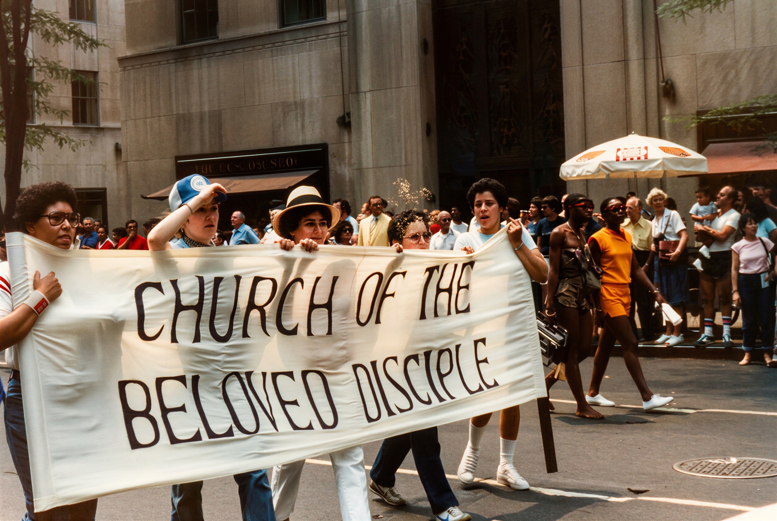 Members of the Church of the Beloved Disciple carry the congregation's banner during New York City's annual Pride Parade, circa late 1970s - early 1980s. The church marched each year as an openly Christian presence within the LGBTQ movement, proclaiming that gay, lesbian, bisexual, and transgender people belonged fully within the life of the Church. While clergy often processed in liturgical vestments and carried crosses and banners, lay members walked alongside them, demonstrating that the Church of the Beloved Disciple was both a worshiping community and a visible participant in the ongoing struggle for equality, dignity, and religious inclusion.