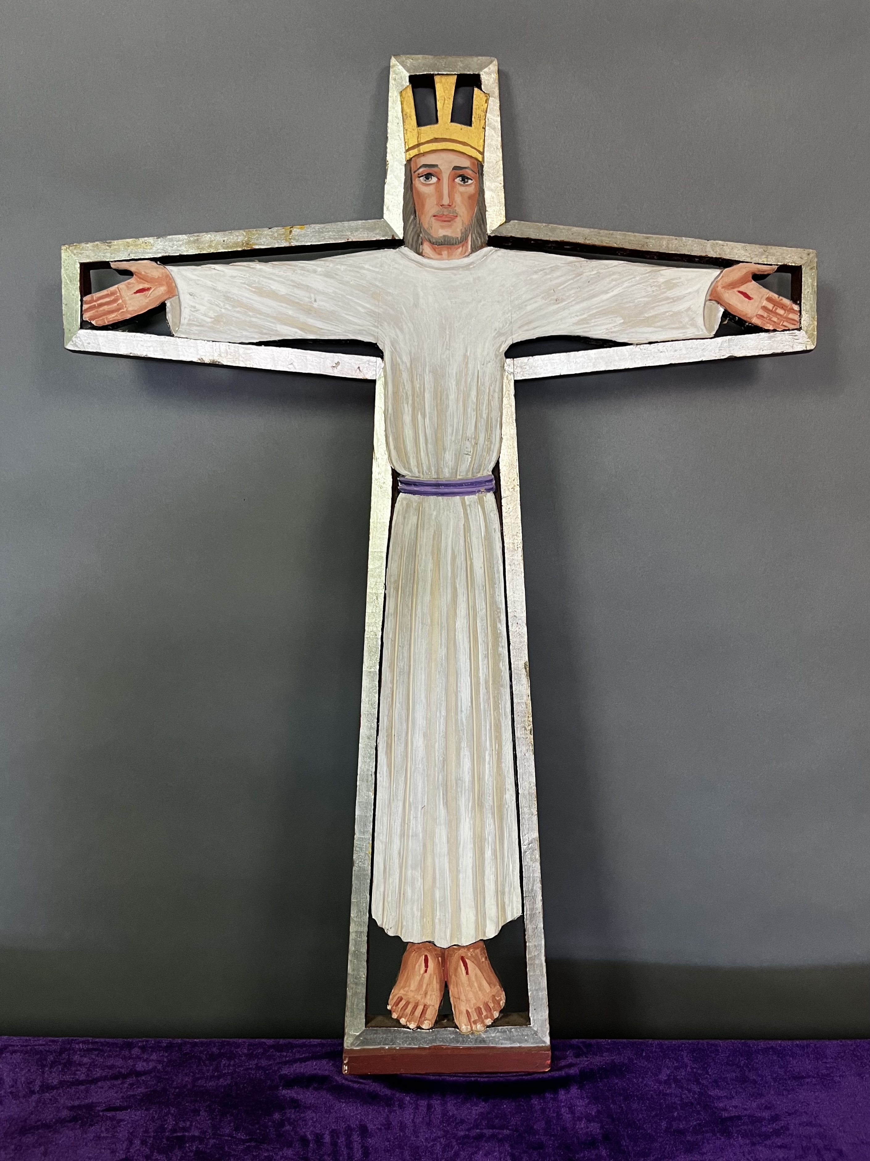 This carved wooden crucifix, created by artist Robert Robbins, served as the principal cross of the Church of the Beloved Disciple throughout its history. First displayed at the congregation's inaugural Eucharist in the Church of the Holy Apostles in Manhattan, it remained a constant presence as the community moved to successive worship spaces, ultimately hanging in the sanctuary at 348 West 14th Street. Depicting the risen and glorified Christ with outstretched arms and visible wounds, the crucifix embodied the church's theology of resurrection, welcome, and reconciliation.