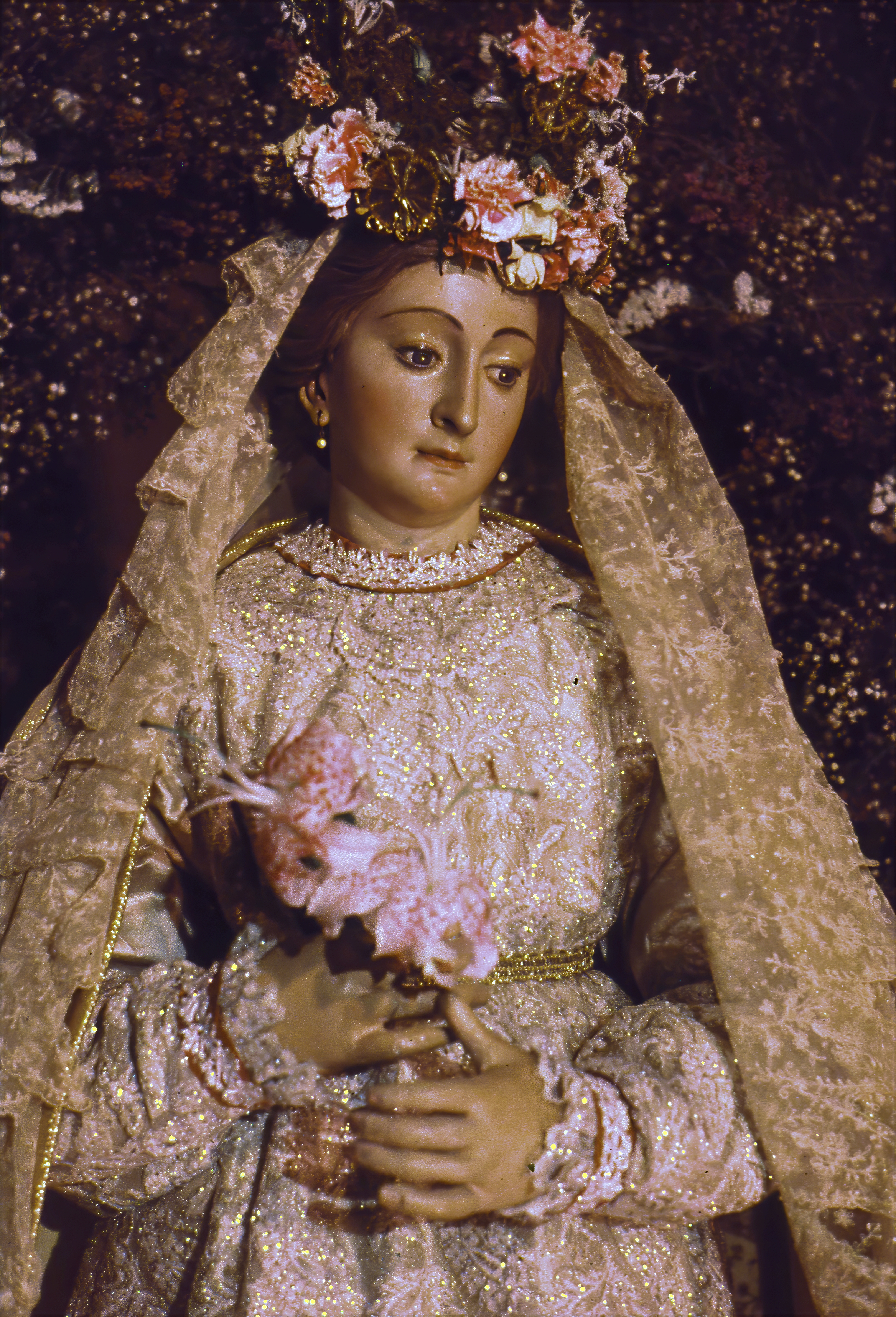 The Church of the Beloved Disciple's statue of the Blessed Virgin Mary was richly adorned with embroidered garments, a lace veil, fresh flowers, and a floral crown prepared for the church's liturgical seasons and Marian feasts. Displayed within the sanctuary and carried in annual processions, the image reflected the congregation's deep devotion to Mary as a symbol of compassion, fidelity, and hope. Through such traditional expressions of piety, the church affirmed its place within the historic Catholic devotional tradition.