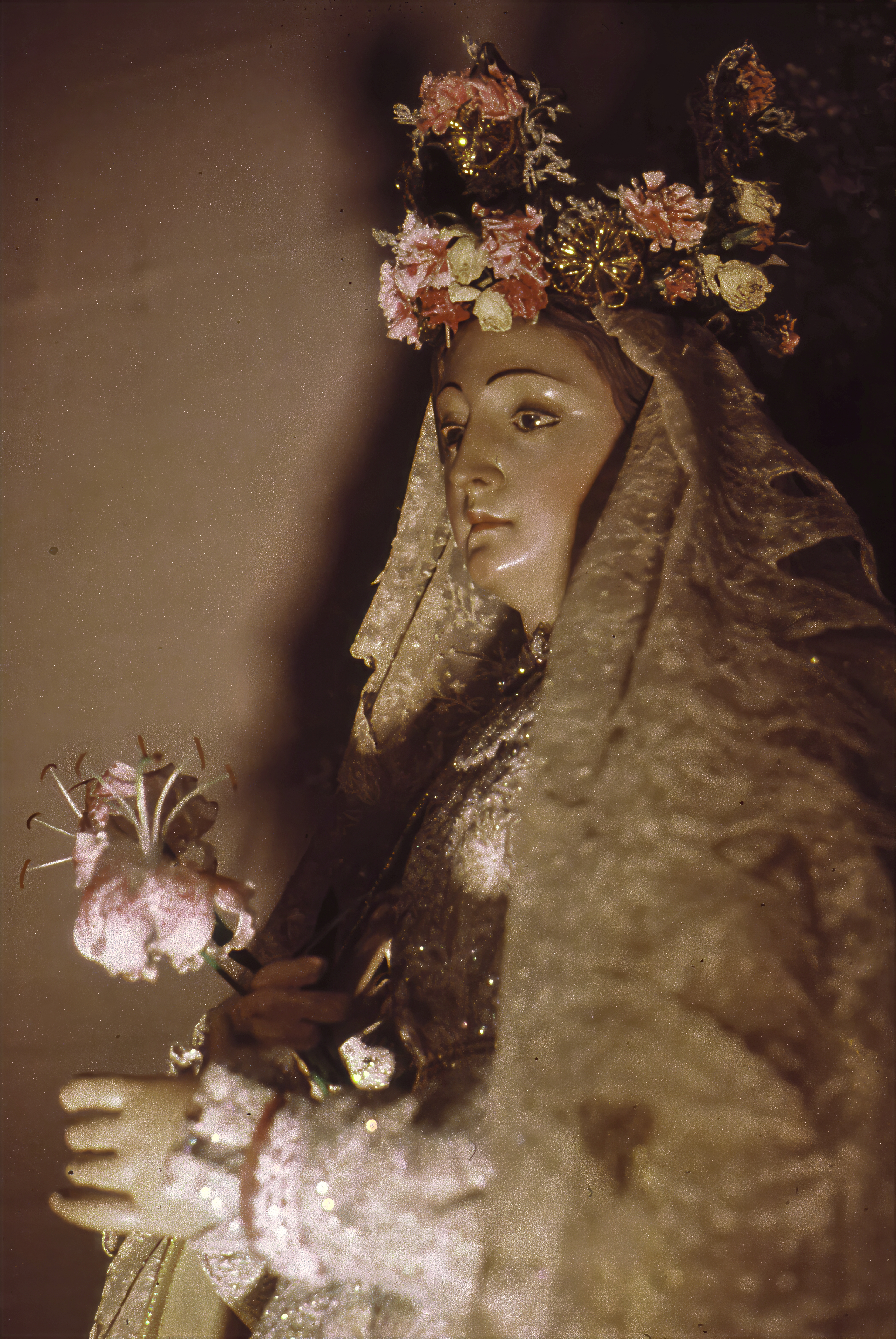 Seen in profile, the church's statue of the Blessed Virgin Mary is dressed in elaborate vestments and crowned with flowers in preparation for a public procession. Carried through the streets on the Feast of the Assumption and other Marian celebrations, the image linked the Church of the Beloved Disciple to centuries of Catholic devotional practice while making that tradition visibly present within New York City's LGBTQ community. The statue became one of the congregation's most cherished symbols of continuity, beauty, and sacred presence.