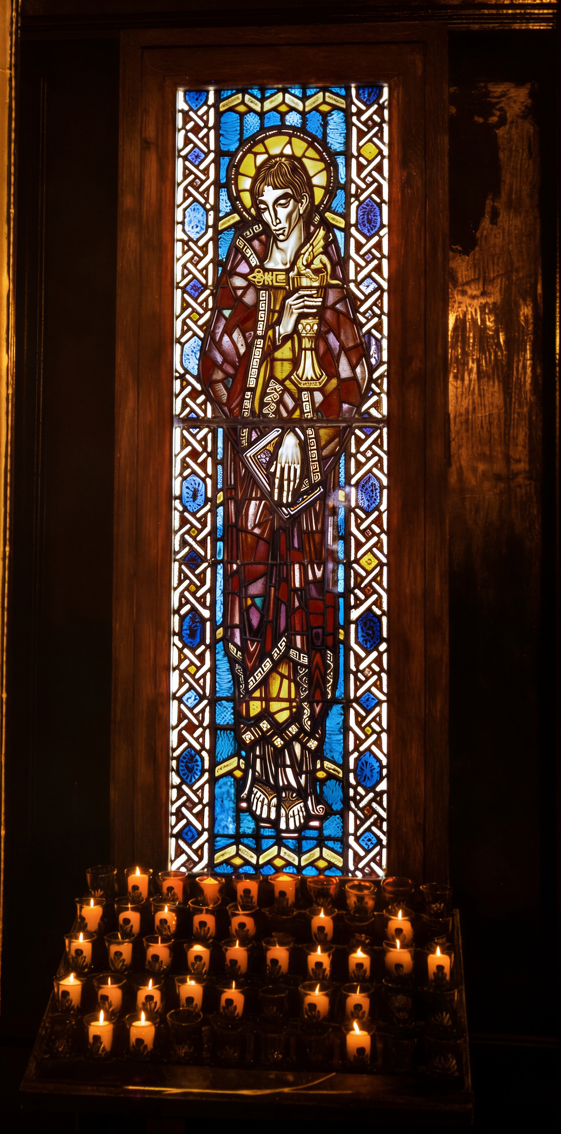 Designed collaboratively by Leo Joseph and John Darcy Noble and executed in England using traditional stained-glass techniques, this window was commissioned for the Church of the Beloved Disciple and imported to New York in 1970. Depicting St. John the Beloved, the church's patron and namesake, it was installed in a side chapel of the congregation's permanent sanctuary in 1973 as a visual expression of its commitment to historic Catholic tradition and an affirming sacramental ministry. The shrine also housed the relics of the Eucharistic Catholic Church, entrusted by Bishop George Augustine Hyde, who founded that church in Atlanta in 1946. By presenting these relics to Bishop Robert Mary Clement and the Church of the Beloved Disciple, Hyde recognized the congregation as the spiritual successor to the Eucharistic Catholic Church, linking its ministry in Manhattan to an earlier independent Catholic tradition and affirming its continuing apostolic mission.