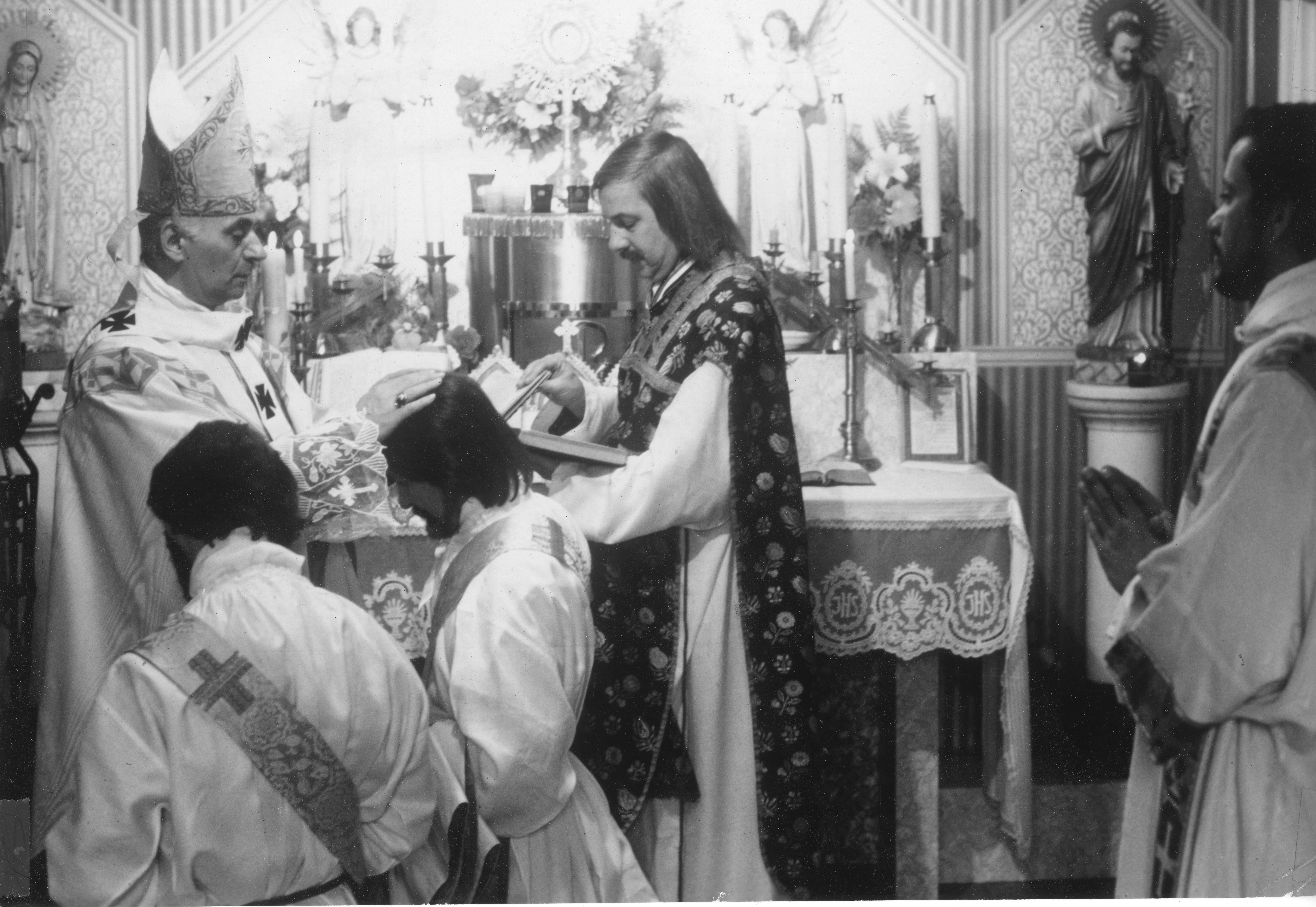 Bishop Thomas J. Fehérváry ordains Father Leo M. Joseph and Father John Darcy Noble to the Catholic priesthood at his chapel in Montreal, Quebec, on April 20, 1974, while Robert Mary Clement assists as liturgical deacon. Celebrated as the first two openly gay men to be ordained as Catholic priests without concealing their sexual orientation, Joseph and Noble would soon become central figures in the ministry of the Church of the Beloved Disciple in New York City. Their ordination by the Hungarian Mariavite Old Catholic bishop, whose apostolic succession traced through the Polish Mariavite Church, provided the sacramental foundation for a ministry dedicated to serving LGBTQ Christians. Less than six months later, Clement himself would be consecrated Bishop of New York, and together the three clergy would help build one of the earliest sacramental communities for gay and lesbian Christians in New York City.