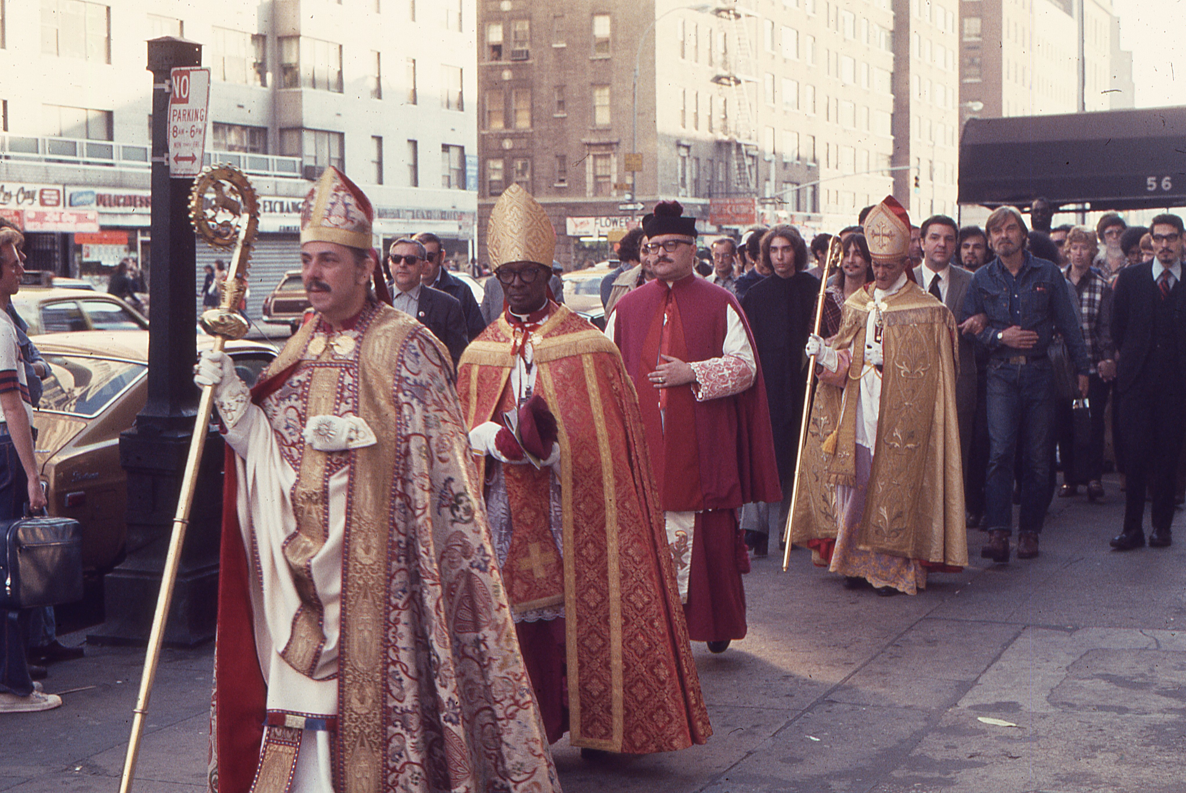 Clergy and bishops process westward through Manhattan following the consecration of Bishop Robert Mary Clement. The procession includes Archbishop Martin Luther Williams, Archbishop Richard Arthur Marchenna, Bishop Robert Clement, and clergy of the Church of the Beloved Disciple, together with supporters from several independent Catholic and Orthodox jurisdictions. Their participation reflected the broad ecumenical relationships that sustained the Church of the Beloved Disciple and affirmed its place within the wider sacramental tradition.
