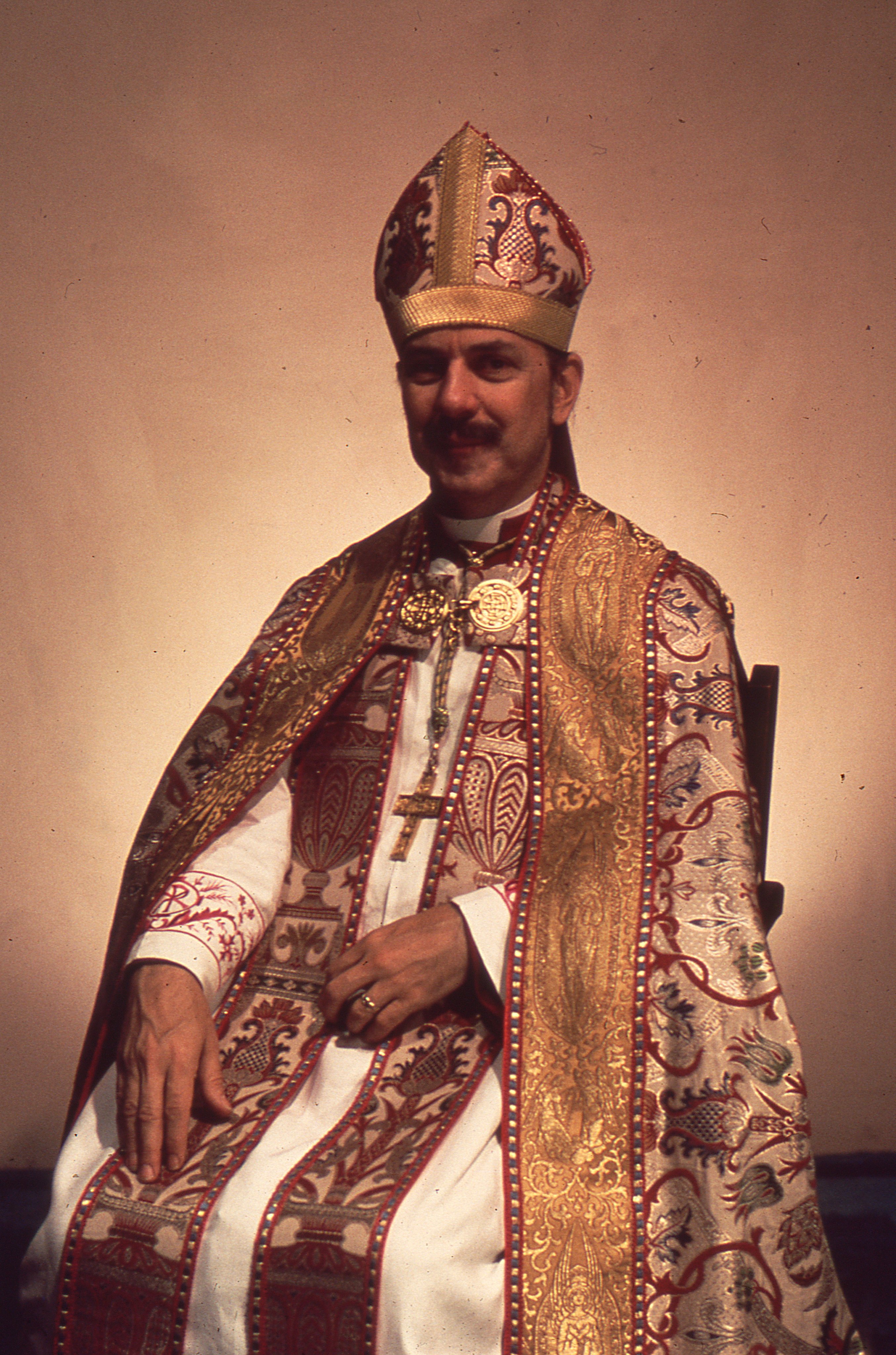 This official portrait of Bishop Robert Mary Clement was taken following his episcopal consecration on October 6, 1974, as Bishop of New York in the Eucharistic Catholic Church. Clothed in richly embroidered pontifical vestments, Clement is presented in the visual tradition of Catholic episcopal portraiture. The image marked the beginning of a new chapter in his ministry, one that combined apostolic succession with an unwavering commitment to providing sacramental ministry and pastoral care to LGBTQ Christians through the Church of the Beloved Disciple.