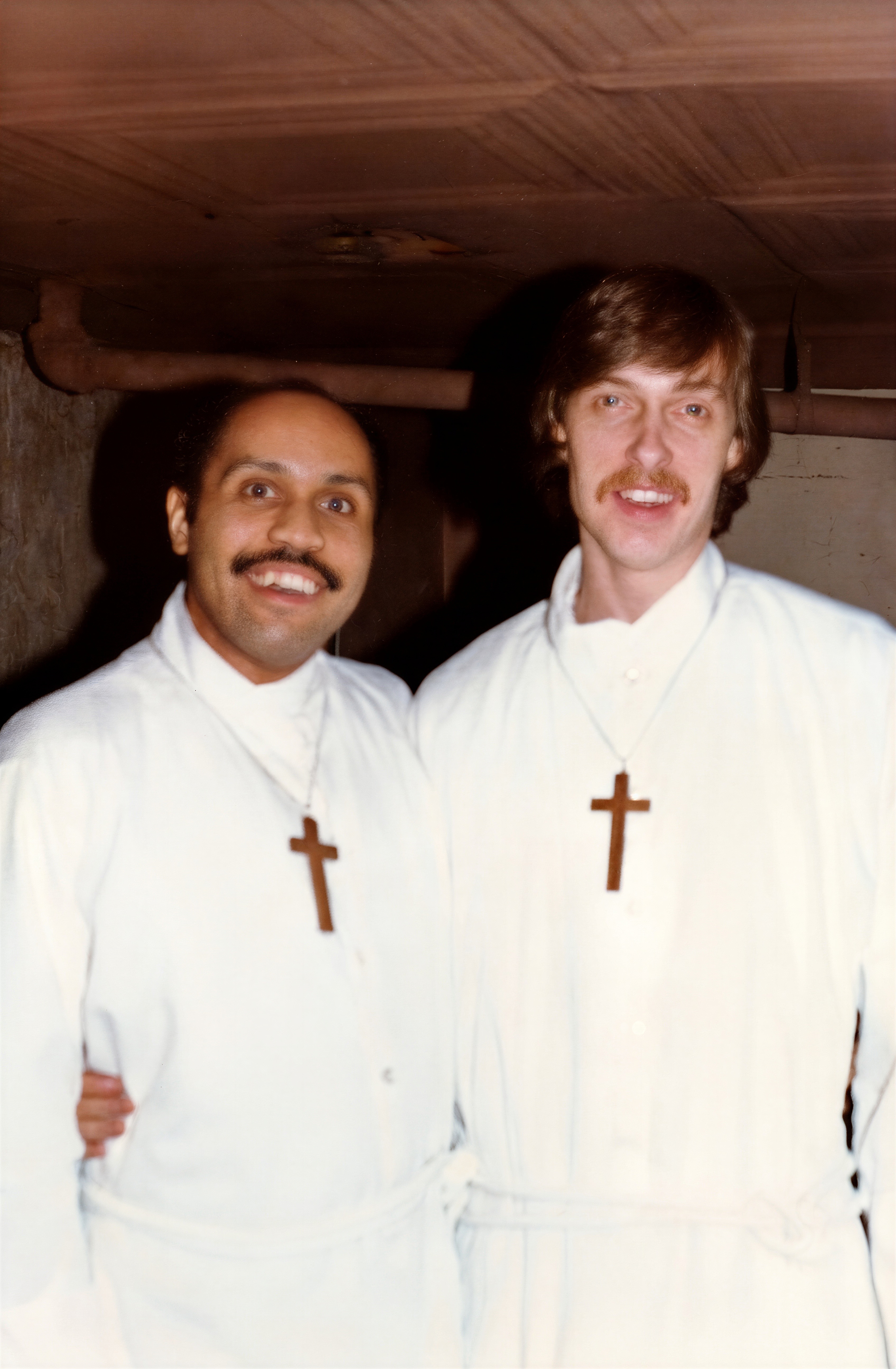 Two unidentified acolytes of the Church of the Beloved Disciple pose together in white liturgical albs and simple wooden crosses before a service. The photograph preserves a rare glimpse of the congregation's lay ministry and the diverse community that participated in the church's liturgical life. While the individuals remain unidentified, they stand as representatives of the many members whose volunteer service helped shape the Church of the Beloved Disciple's distinctive and inclusive ministry.